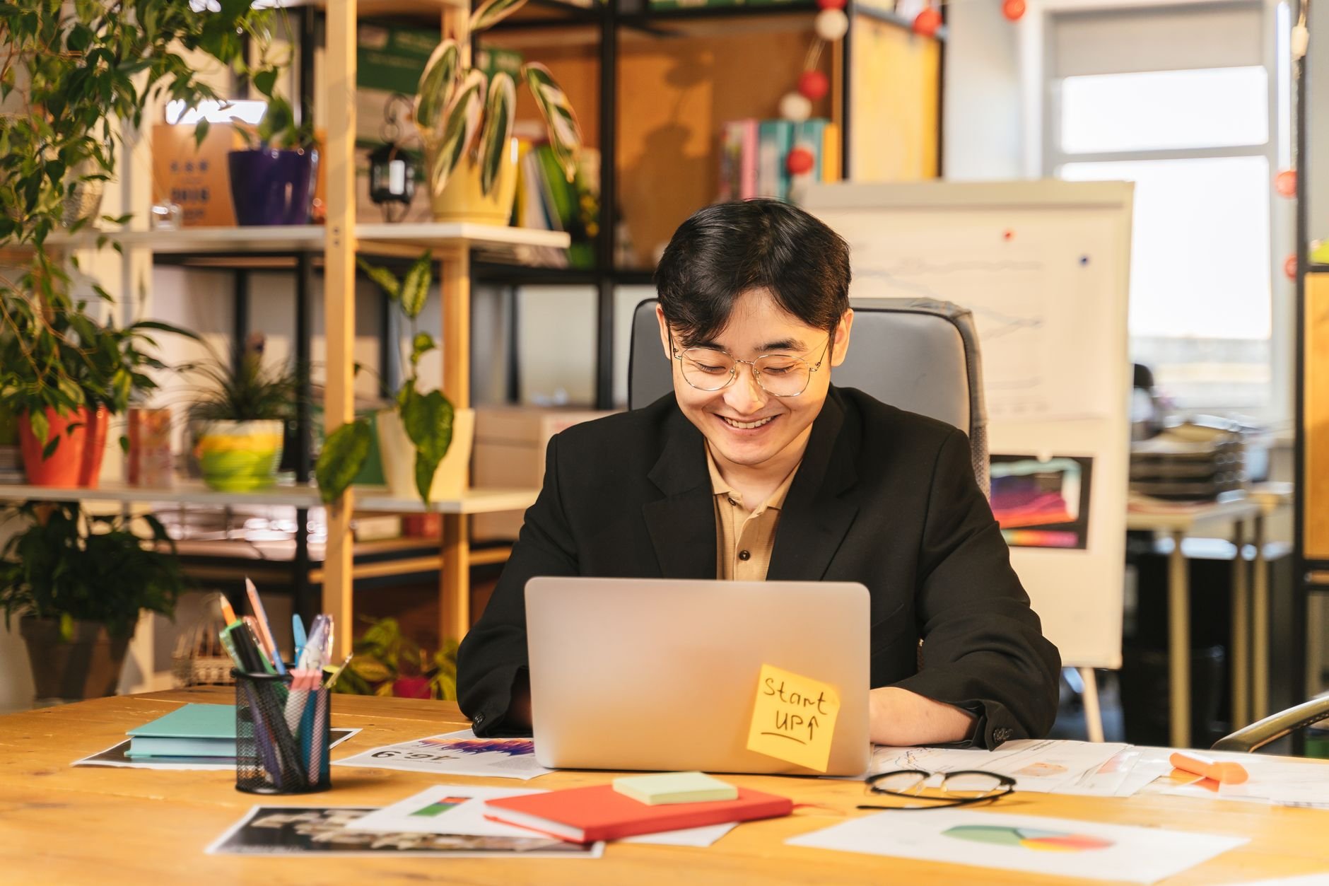 Professional in business attire working at a desk — representative of senior technical leadership.